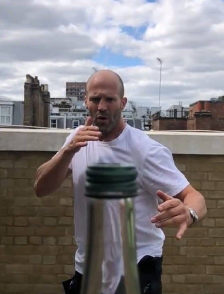 Create meme: Jason Statham , Jason Statham opens a bottle, Jason Statham with a bottle