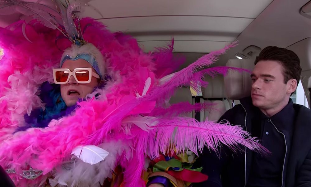 Create meme: Richard Madden and Taron Edgerton in the car, Meme with Elton John in the car, Elton John in feathers