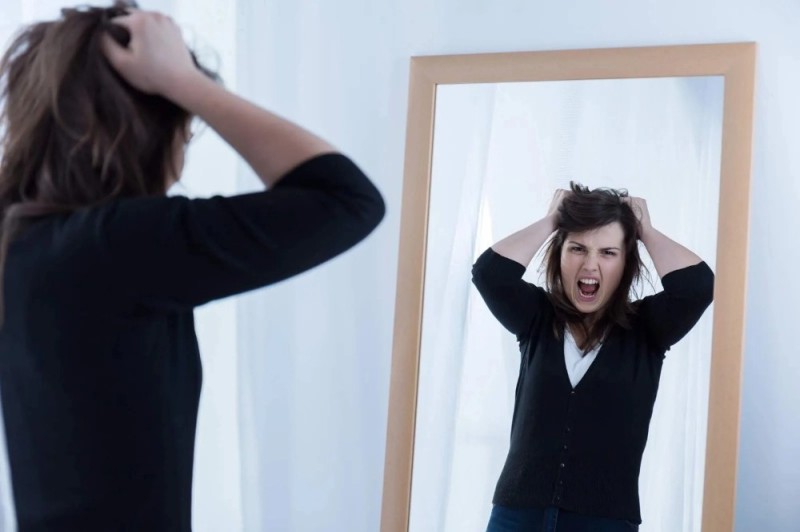 Create meme: reflection in the mirror, pulling hair, a disgruntled woman in front of a mirror