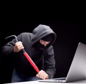 Create meme: photo hacker behind a computer, hacker in a Balaclava, a thug behind a computer