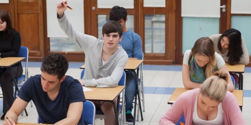 Create meme: the student at the desk, a student in the exam, College students