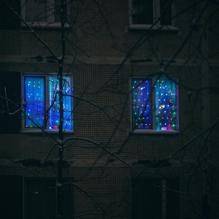 Create meme: garland on the window, a window with a garland from the street, windows at night