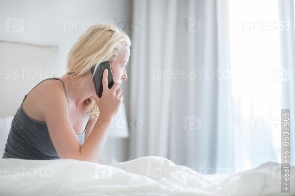 Create meme: woman with handset, A girl is talking on the phone on the bed, The blonde is on the phone