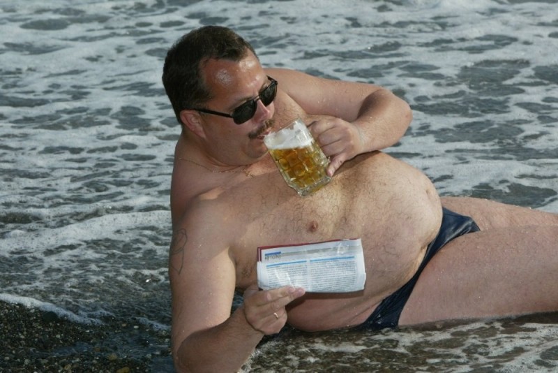 Create meme: fat man on the beach, men with beer bellies on the beach, fat man at sea