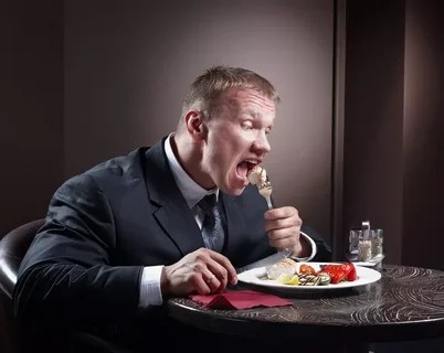 Create meme: A man eats at a table, hungry people, The man is eating