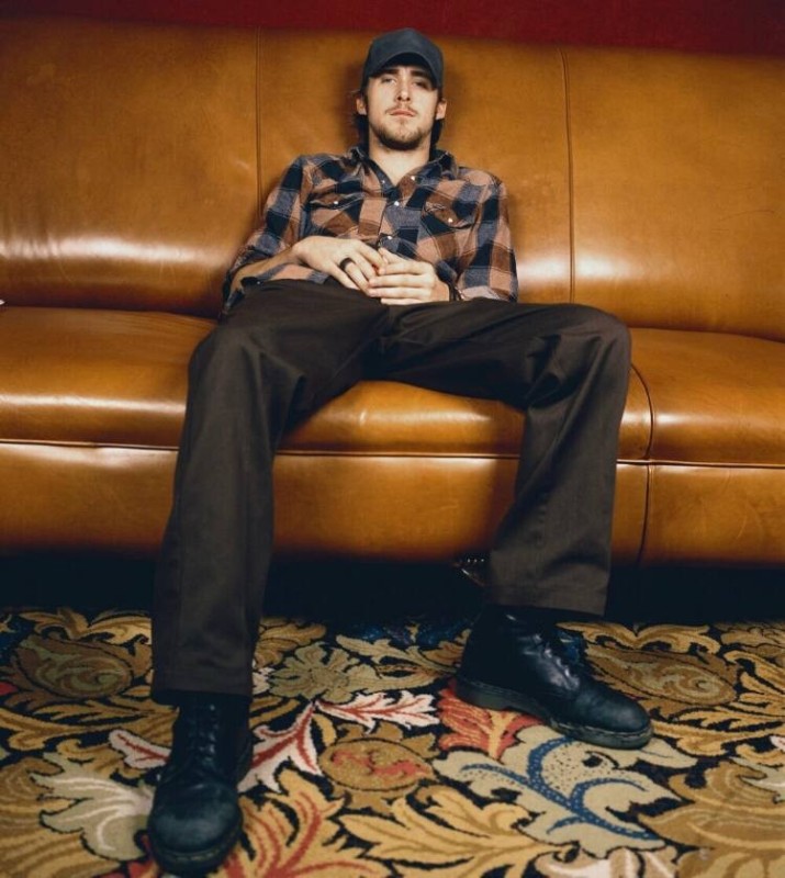 Create meme: Ryan Gosling is sitting on a chair, Ryan Gosling in a cap, Ryan Gosling on a chair