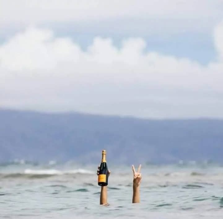 Create meme: beer by the sea, A hand with beer from the water, bottle with message in the sea