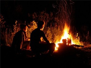 Create meme: evening campfire, couple on the nature of the fire, the fire