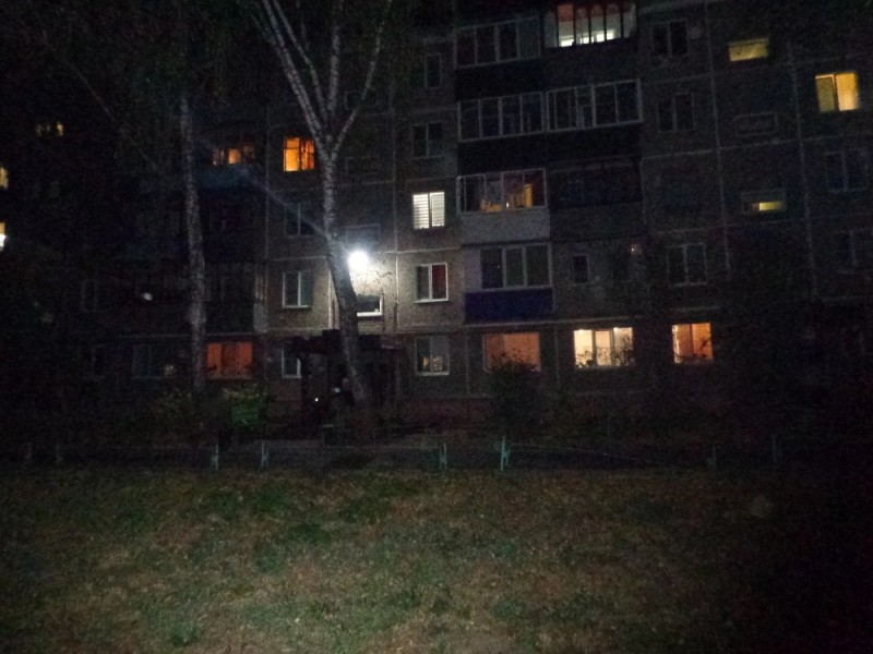 Create meme: multi-storey house at night, a fire in a residential building , yard lighting