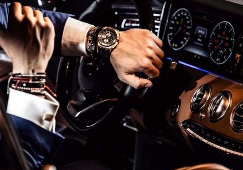 Create meme: A man's hand with a watch, expensive watch and car, men's wristwatch ulysse nardin maxi marine chronometer