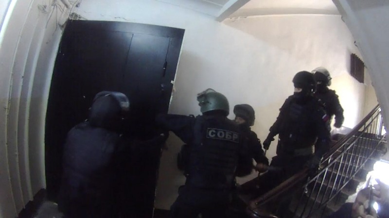 Create meme: riot police in the peephole, special forces assault, sobr granit St. Petersburg