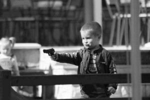 Create meme: Kid with the gun