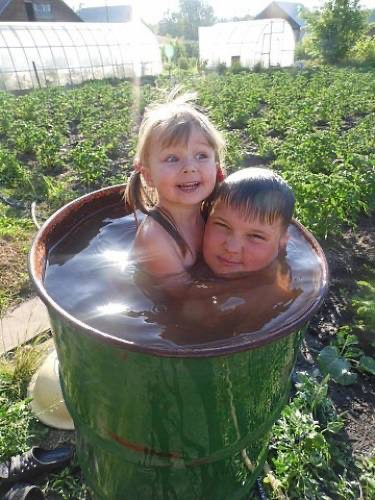 Create meme: swimming in a barrel at the dacha, a barrel in the country, bathing in a barrel