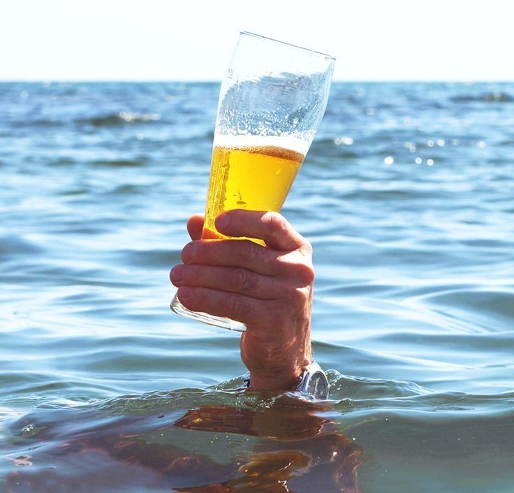 Create meme: A hand with beer from the water, beer on the beach, hand with beer