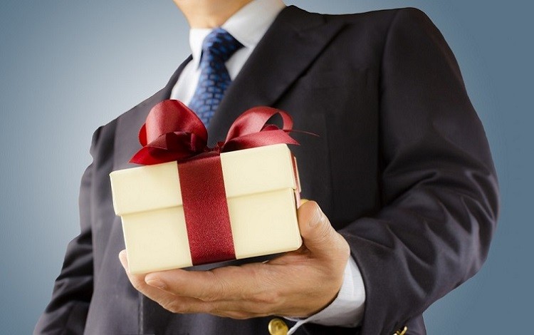 Create meme: a man gives a gift, presentation of a gift, business gifts