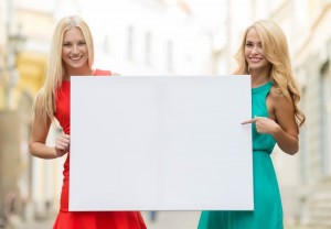 Создать мем: поступление товара, девушка с плакатом в руках, девушка для баннера