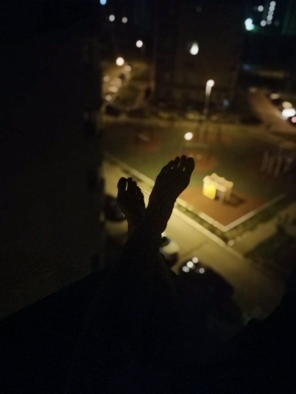 Create meme: roof at night, on the edge of the roof at night, feet on the edge of the roof at night