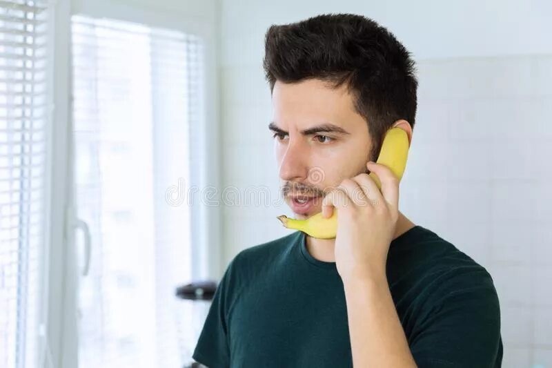 Create meme: 9037139906 scammers are calling, a man holds a banana, talking on the phone