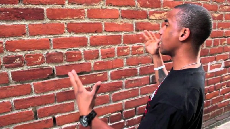 Create meme: the black speaks with the wall, a man is talking to a wall, the negro talks to the wall