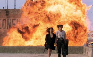Create meme: cool guy and a blast on the background of the gif, the explosion, two people and an explosion in the background