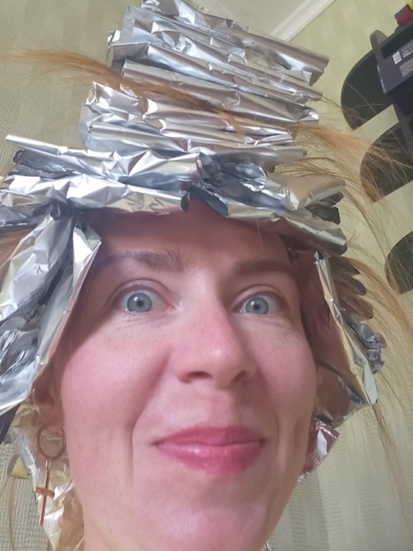 Create meme: woman , The girl with the foil on her head, highlighting with foil