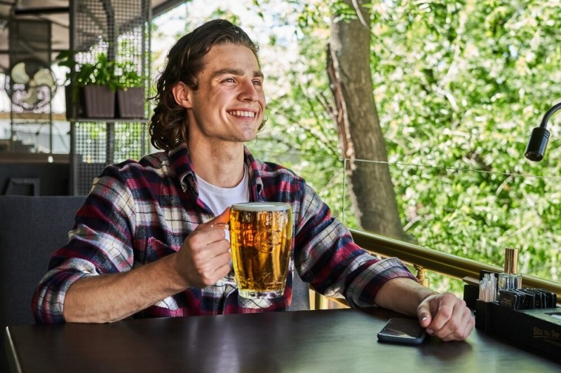 Create meme: a man drinks beer, a man in a bar with a beer, the man with the beer