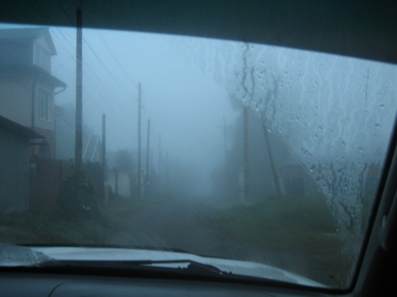 Create meme: thick fog , car , village road