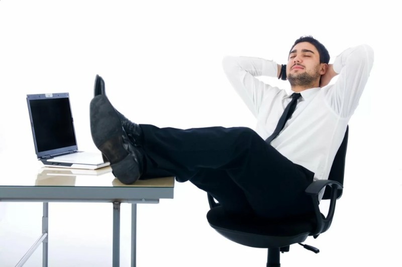 Create meme: relaxing in the office, feet on the table, The man put his feet up on the table