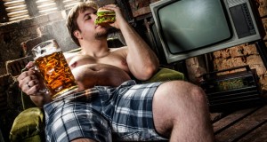 Create meme: a man with a beer belly photo, the guy on the couch with a beer, the man on the couch with a beer