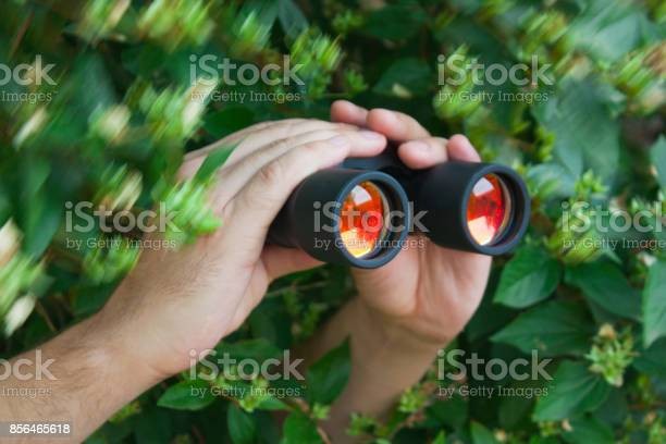 Create meme: looking through binoculars, binoculars , a man looks through binoculars