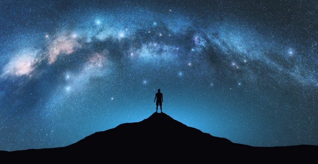 Create meme: Are we alone in the universe, space milky way, a man on the background of the starry sky