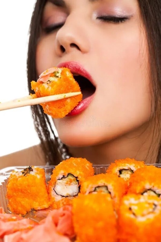 Create meme: a girl eats sushi, rolls on a girl, a girl eats rolls