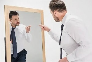 Create meme: a man is arguing with a mirror, a man looks in the mirror, the man in front of the mirror