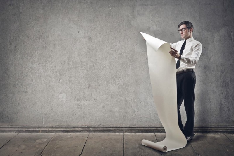 Create meme: a man on a gray background, a large piece of paper, on a gray background