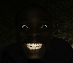 Create meme: black, dark, Negro in the dark, Negro laughing in the dark