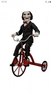 Create meme: the doll from saw on the bike, Billy doll on the bike, saw on the bike