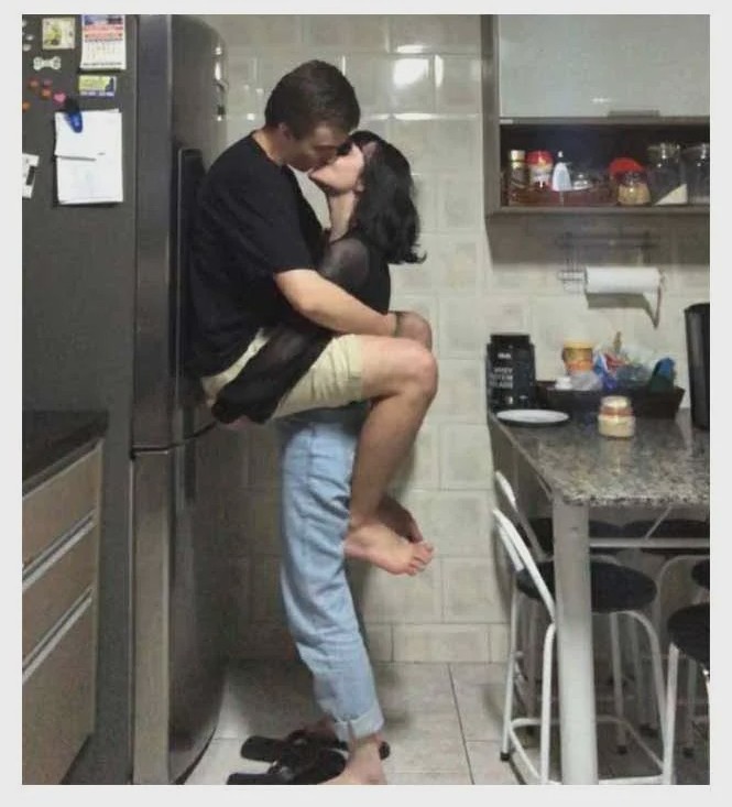 Create meme: lovers in the kitchen, steamy photo shoot in the kitchen, A man tells a woman a meme