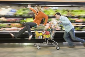 Create meme: the girl in the grocery cart, man with cart in supermarket, a woman with a trolley at the supermarket