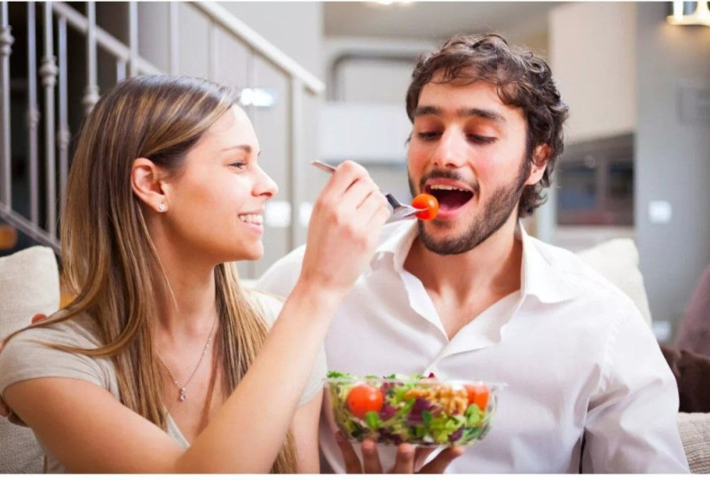 Create meme: male , the girl feeds the guy, guy 