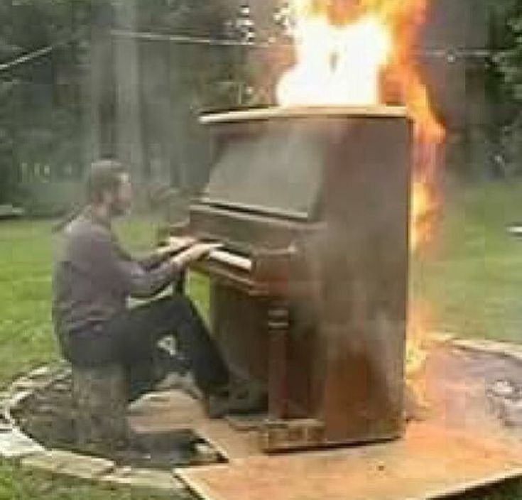 Create meme: burning piano, playing the burning piano, burning piano meme