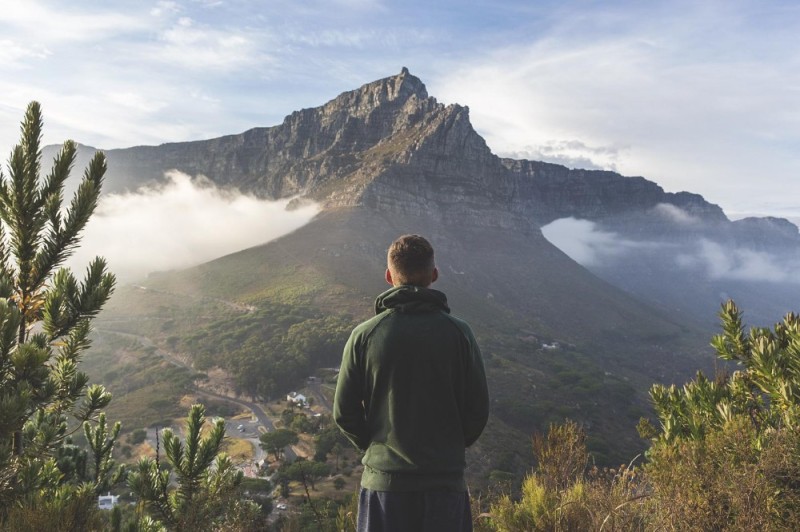 Create meme: a man on top of a mountain, in the mountains, mountains man