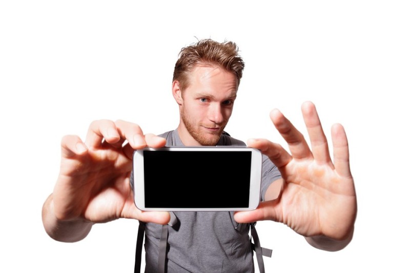 Create meme: The man shows the phone, smartphone in hand, With the phone in his hands