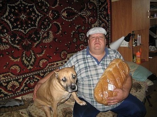 Create meme: a man is sitting with a loaf and a dog, a man with a loaf and a dog meme, The man with the loaf