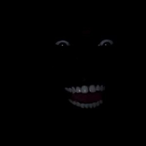 Create meme: scary face in the dark, ebony smiles in the dark, Negro laughing in the dark