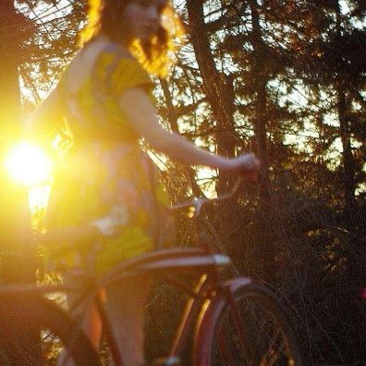 Create meme: girl with a bicycle, darkness, sun shine through