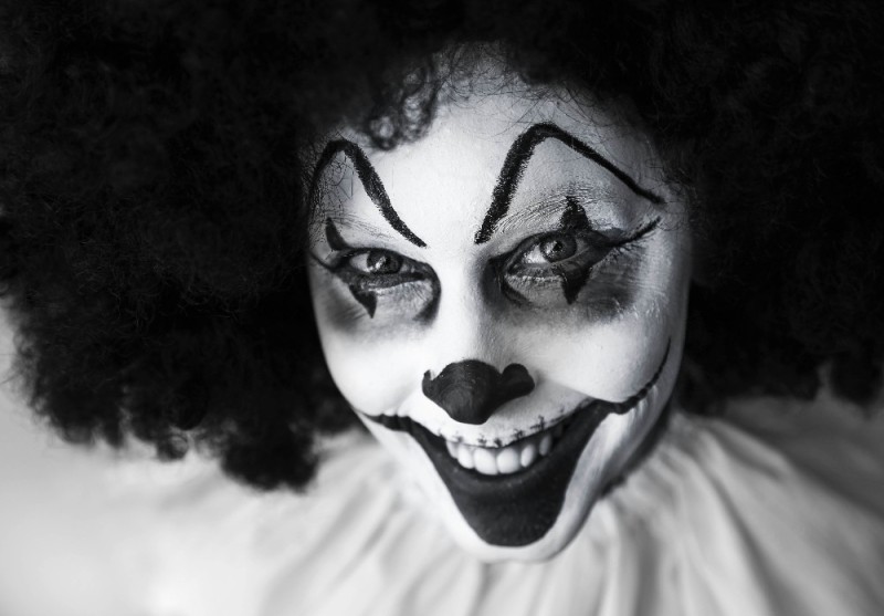 Create meme: scary clown on a black background, black clown, fake clown