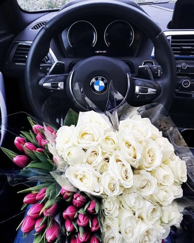 Create meme: flowers in bmw, BMW with flowers, flowers on the hood of a BMW