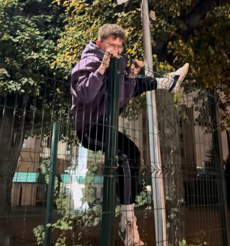 Create meme: gopnik on a horizontal bar, people, over the fence