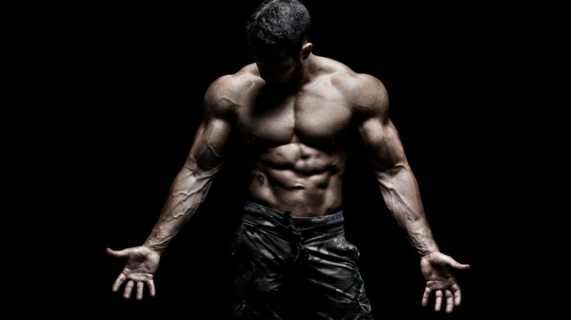 Create meme: bodybuilder , body on a black background, muscular man