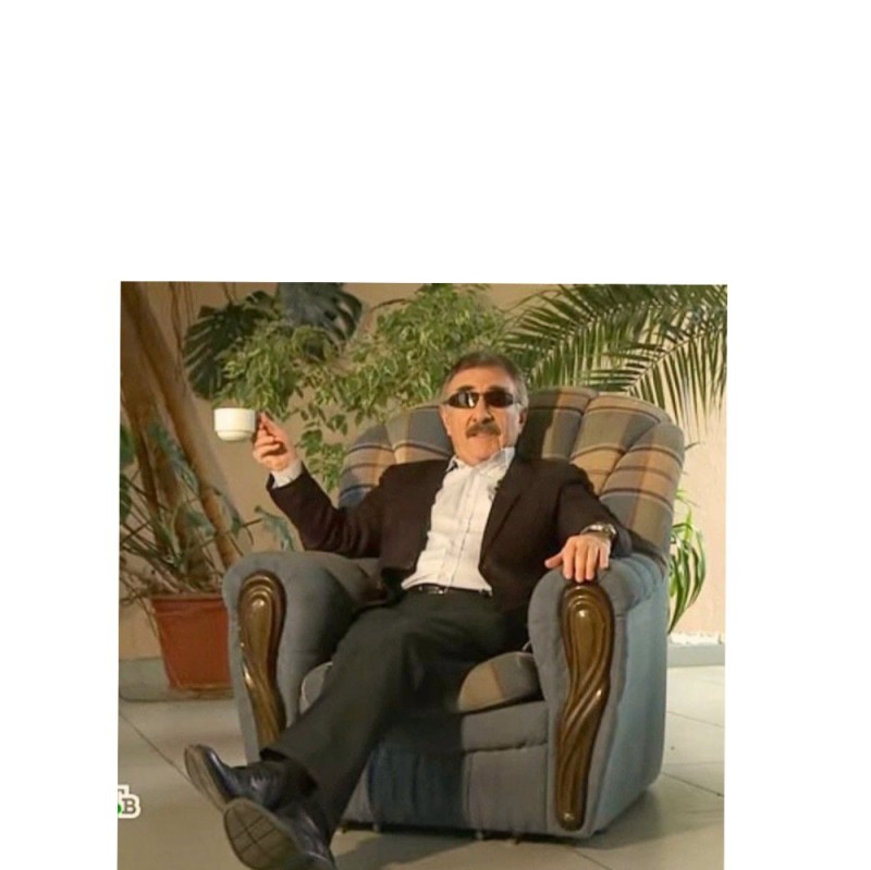 Create meme: mug white, Leonid Kanevsky in a chair, Leonid kanevsky drinks tea